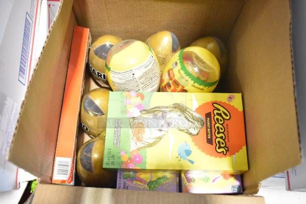 Cardboard box with various candies, including Reese's chocolate bunny. Includes Starbursts, Haribo eggs, and Peeps. New condition.