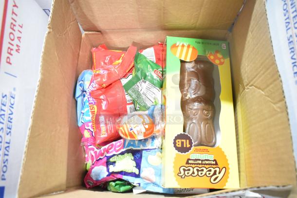 10 boxes of assorted candy, including Starbursts, a Reese's Chocolate Bunny, and Pudding Peeps, in a USPS Priority Mail box.