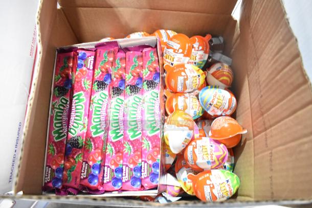 Box containing Mamba candy packs and Kinder Joy eggs, part of an auction item of 10 candy boxes.
