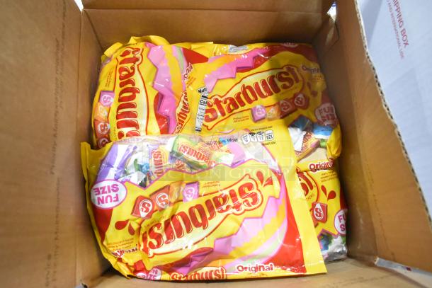 Box containing multiple bags of Starbursts fun-size candy, branded yellow packaging visible, new condition.
