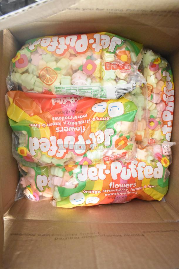 Box containing multiple bags of Jet-Puffed Marshmallows with floral shapes and flavors like orange, strawberry, lemon, and lime.