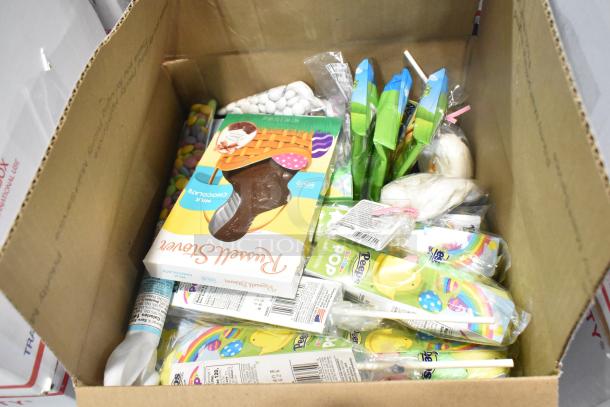 Box containing various candy brands including Jet Puffed Marshmallows, Peeps, Sour Punch, Hershey's Eggs, KitKats.