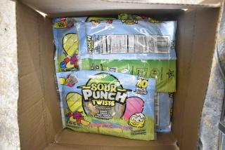 Box of Sour Punch Twists candy packs, assorted flavors, labeled 40 pieces per pack, part of 10 box candy auction.