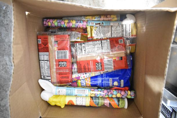 Box of candy assortment including Sour Punch Twists, Junior Mints, Sour Patch Kids, Jef Puffed Marshmallows, Reese's.