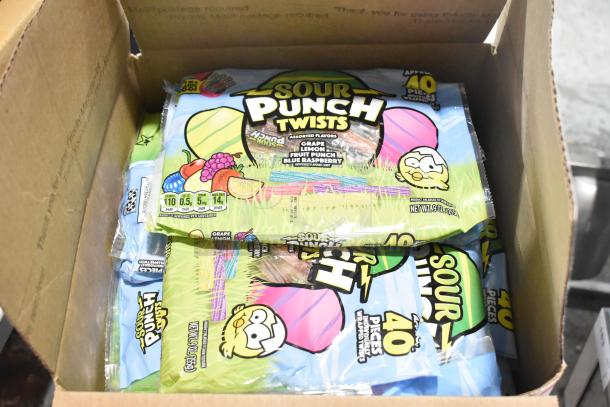 Box containing Sour Punch Twists candy packs, 9 oz each, assorted flavors. Auction includes 10 boxes of various candies.