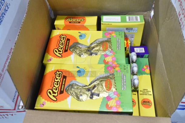 10 boxes of candy, featuring Reese's, Junior Mints, Sour Patch Kids, and more. Includes festive Reese's packaging.