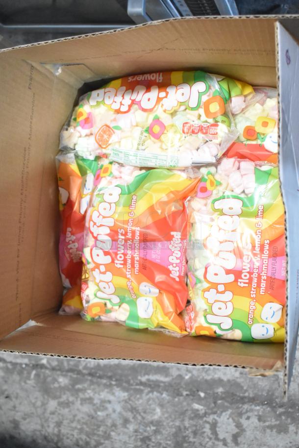 10 boxes of assorted candy including Jef Puffed Marshmallows in flower shapes, visible packaging in a cardboard box.