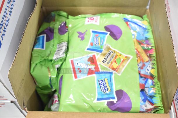 Ten boxes of mixed candy including Jef Puffed Marshmallows, chocolate bunnies, and Reese's. Sealed packaging with candy labels.