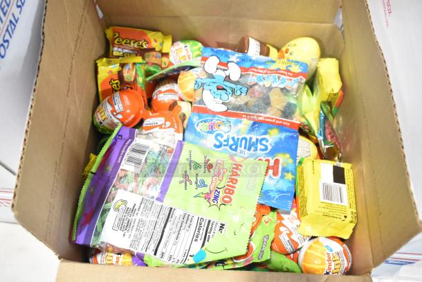 Box of assorted candy including Jef Puffed Marshmallows, Reese's, chocolate bunny, Haribo, and Kinder Joy. Various conditions.