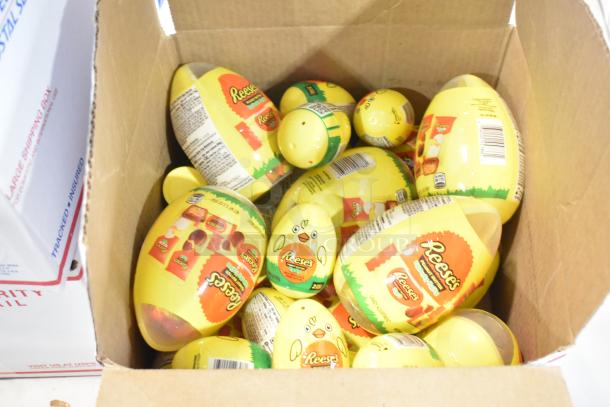 Box of Reese's Easter candy eggs, yellow packaging, assorted sizes, ideal for holidays and gifting.