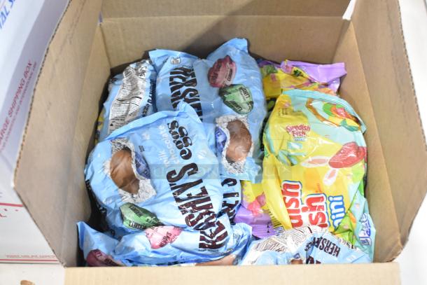 Box of various candies including Hershey's milk chocolate eggs, Swedish Fish mini, and other Easter-themed treats.