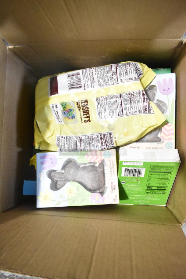 10 candy boxes in a cardboard box featuring Hershey's assortment, rabbit-shaped chocolates, and nutrition labels visible.