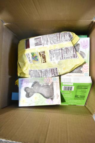 10 candy boxes in a cardboard box featuring Hershey's assortment, rabbit-shaped chocolates, and nutrition labels visible.