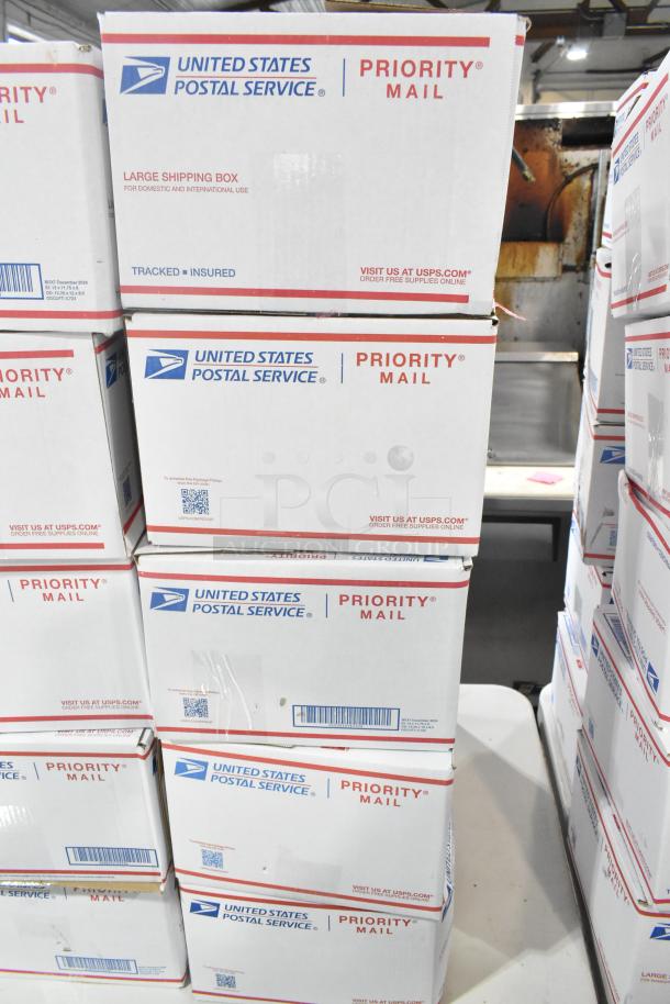 10 USPS Priority Mail boxes containing various candy, including Mamba Berrytastic, Lindt Lindor, and Russell Stover.