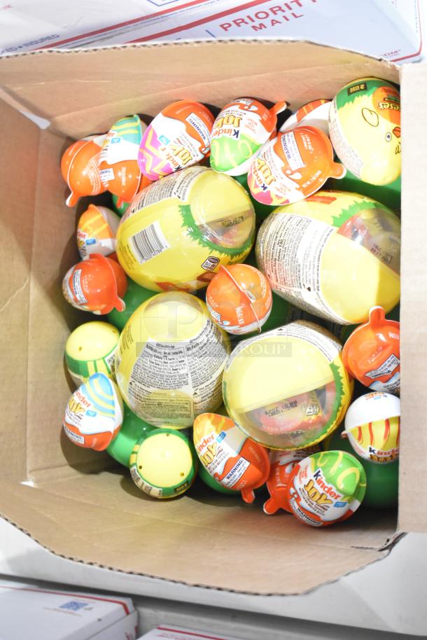 Box of assorted Kinder Joy eggs, mixed flavors, in new condition. Contains labels with product details and safety warnings.