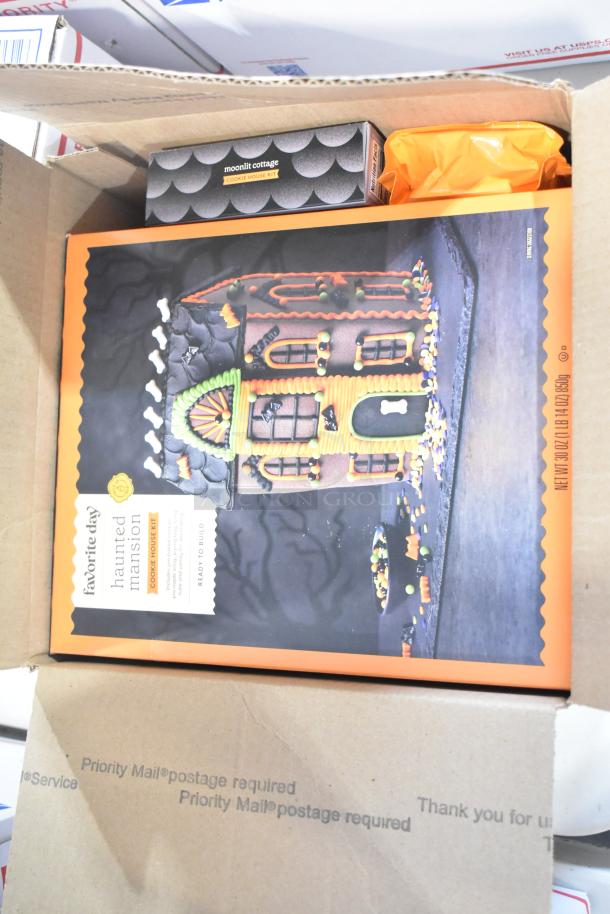 Box containing a Favorite Day Haunted Mansion cookie kit and Moonlit Cottage kit, surrounded by packaging materials.