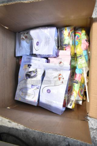 Open box showing assorted candy including Peeps, Lindt chocolates, and other treats. Ideal for bulk purchase.