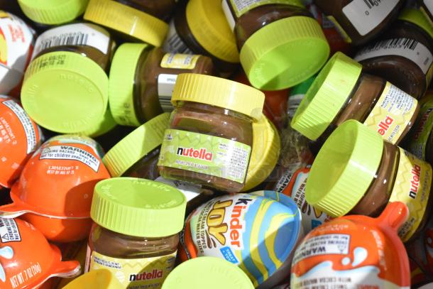 10 boxes of assorted candy including Nutella jars and Kinder Joys, brightly colored packaging, new condition.