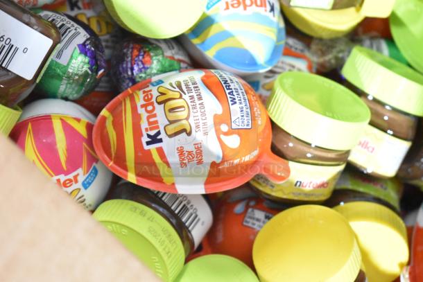 Assortment of candies including Kinder Joy, Nutella jars, and chocolate eggs. Retail packaging visible. Various flavors.