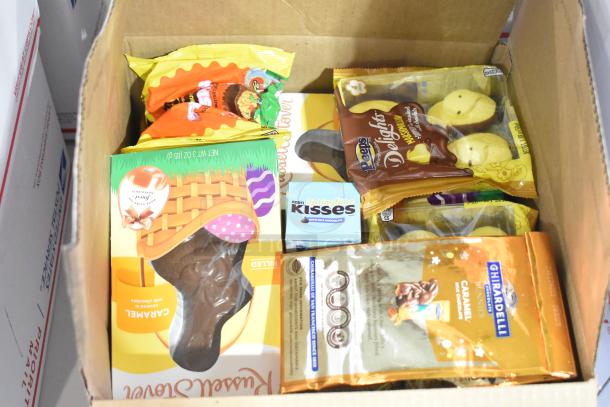 Box of assorted candies including Peeps, chocolate bunnies, Nutella, and Kinder Joys, displayed in packaging.