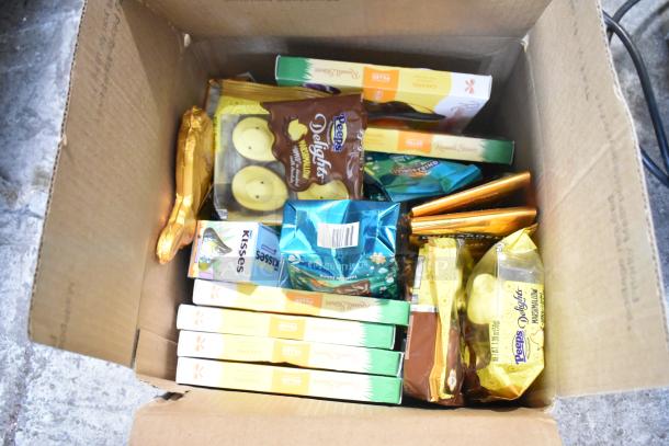 Box of assorted candies including Reeses, Peeps marshmallow, Hershey's Kisses, and chocolate bunnies. 10 boxes available.