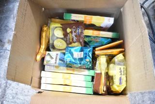 Box of assorted candies including Reeses, Peeps marshmallow, Hershey's Kisses, and chocolate bunnies. 10 boxes available.