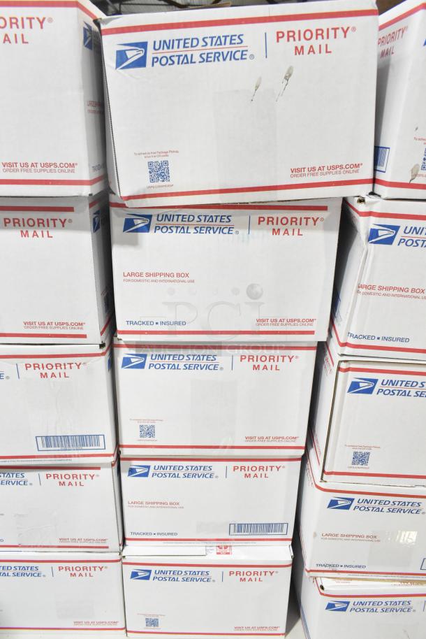 Stack of United States Postal Service Priority Mail boxes containing 10 assortments of candy including Reese's and Peeps.
