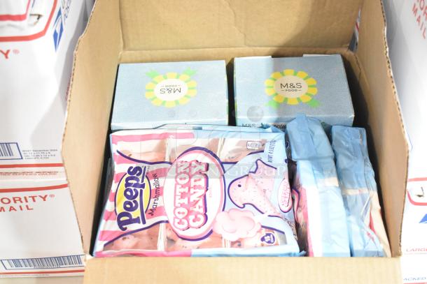 A box containing Peeps Cotton Candy marshmallows and M&S Food boxes. Multiple candy items included for auction.