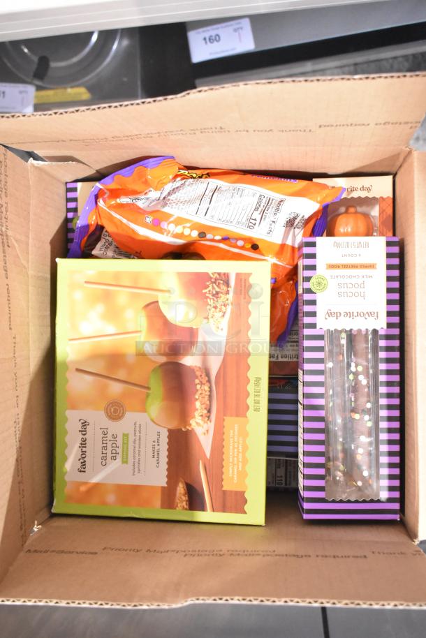 Box containing various candy items including Nutella, chocolate bunnies, M&Ms, Hershey's eggs, and Sour Patch twists.