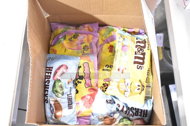 10 boxes of assorted candy including Nutella, chocolate bunnies, M&Ms, Hershey's eggs, Sour Patch Twists.