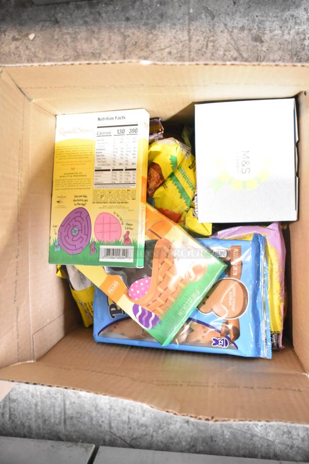 Box of assorted candies including Nutella, chocolate bunnies, M&Ms, Hershey's eggs, and Sour Patch Twists.