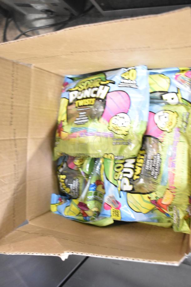 Box of assorted candy packs including Sour Punch Twists. Contains multiple candy varieties for sale.