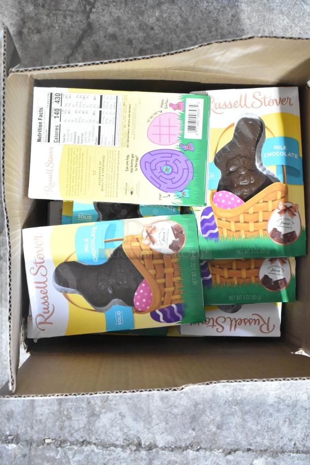 10 boxes of various candy including Russell Stover chocolate bunnies, visible nutritional labels, excellent condition.
