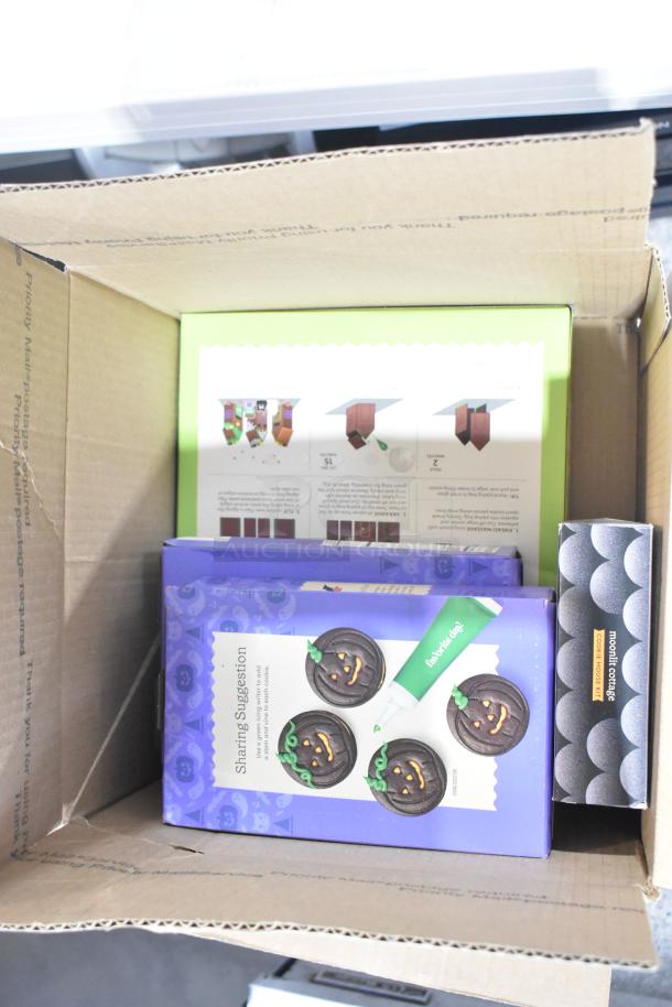 10 boxes of assorted candy, including Jet Puffed Marshmallows, Starburst Jellybeans, and chocolate bunnies, displayed in an open cardboard box.