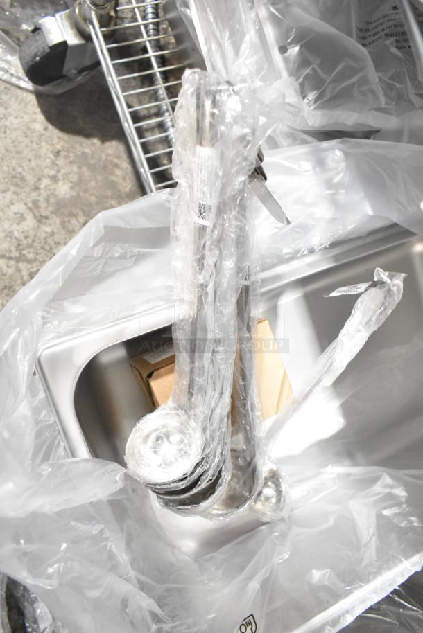 29 brand new Choice ladles and Vigor stainless steel bins, wrapped, slightly scratched. Includes 2 oz and 4 oz ladles.