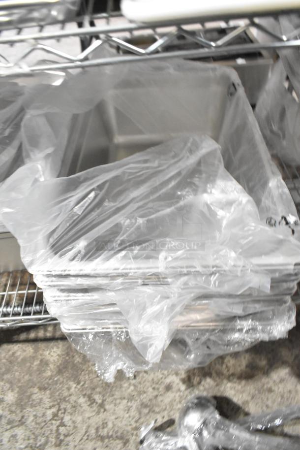 29 brand new scratch and dent items, including Choice 407OPL2 2 oz ladle, 407OPL4 4 oz ladle, and Vigor stainless steel drop-in bins, wrapped in plastic.