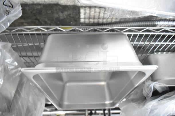 29 brand new scratch and dent items on a shelf, including Vigor stainless steel drop-in bins.