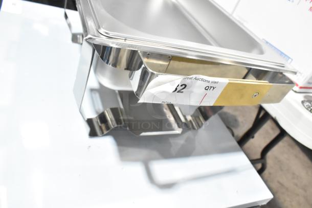 Brand new chafer with minor scratches and dents, stainless steel body, auction label visible showing item details.