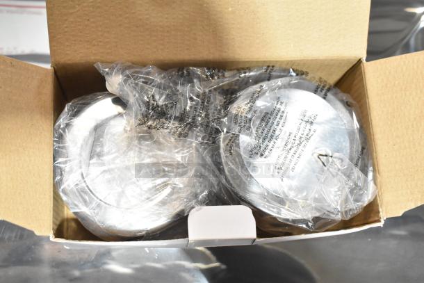 Brand new chafer in original packaging, visible scratches and dents, sealed in plastic, includes metal lids.