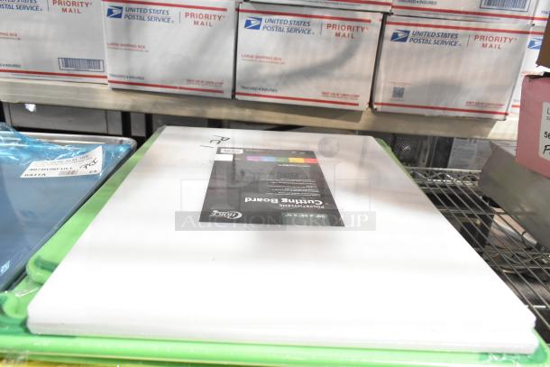 New scratch and dent kitchen items, including baking pans and cutting boards. Labeled “Choice Polyethylene Cutting Board.”