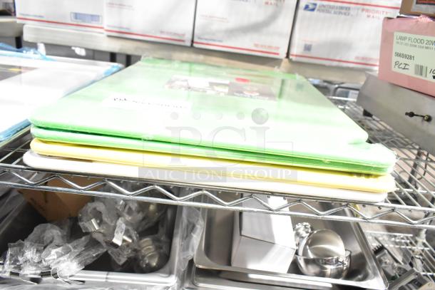 Stack of colorful cutting boards and baking pans on metal rack; items labeled "brand new" despite being scratch and dent.
