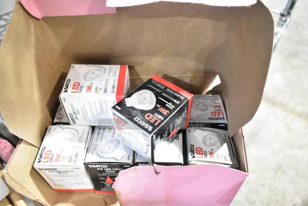 Box of Satco LED MR11 3W 3000K light bulbs, new scratch and dent condition, labeled with specs and 25,000-hour lifespan.