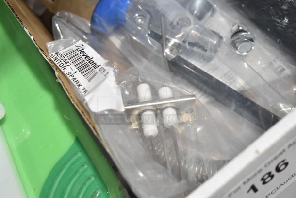 Brand new Cleveland KE53437-1 spark igniter in packaging, labeled "Ignitor: Spark Tr." Includes metal and ceramic components.