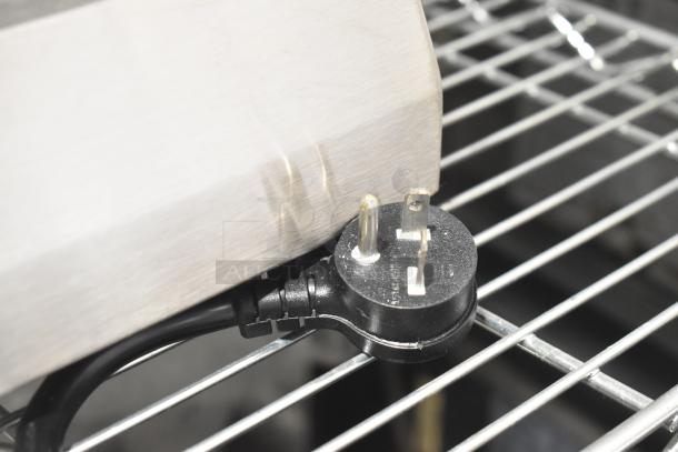 Avantco countertop single burner induction range with visible scratch and power cord plug on metal surface.