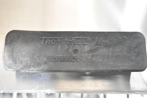 Brand new Troy Hill hinge lid with surface scratches. Marked "TROY HILL Mfg., TOWACO N.J." Durable black material.