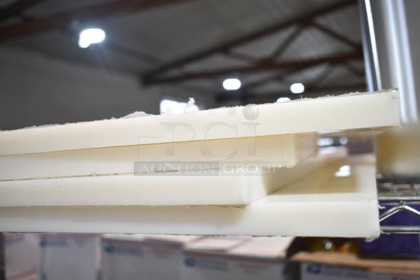 Stack of four white cutting boards, part of a 5-item auction set including a 471SP60QT Choice 60 Qt. stock pot. Scratch and dent condition.