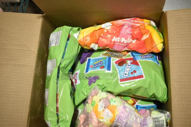Box with assorted candy including Jet-Puffed Marshmallows, Twizzlers, and Jolly Ranchers. Variety pack, 11 boxes total.