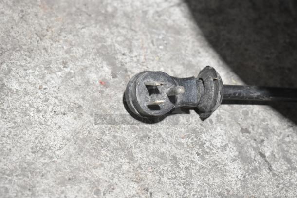 Close-up of a power plug from the Avantco 177MX20H dough mixer, showing the three-prong design on a concrete surface.