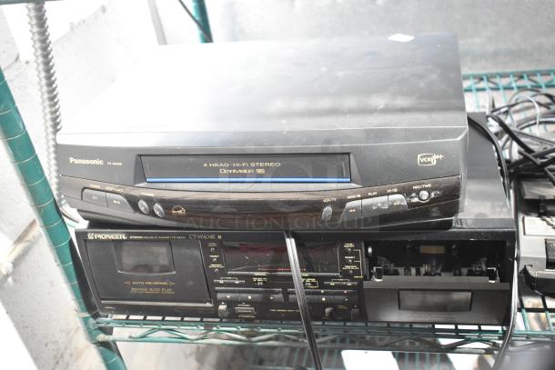 Panasonic PV-8455S VHS Player and Pioneer CT-W404R Stereo Double Cassette Deck on metal shelf, visible signs of wear.