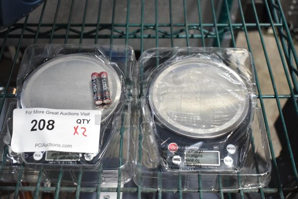 2 Galaxy PCR10 10 lb. digital portion control scales, brand new with minor scratches, include batteries, in packaging.